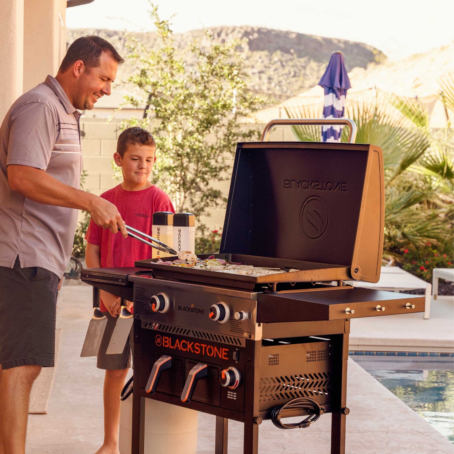 The Foalyard Blackstone 28-inch Gas Griddle Plus AirFryer Combo and Hood - dad and son