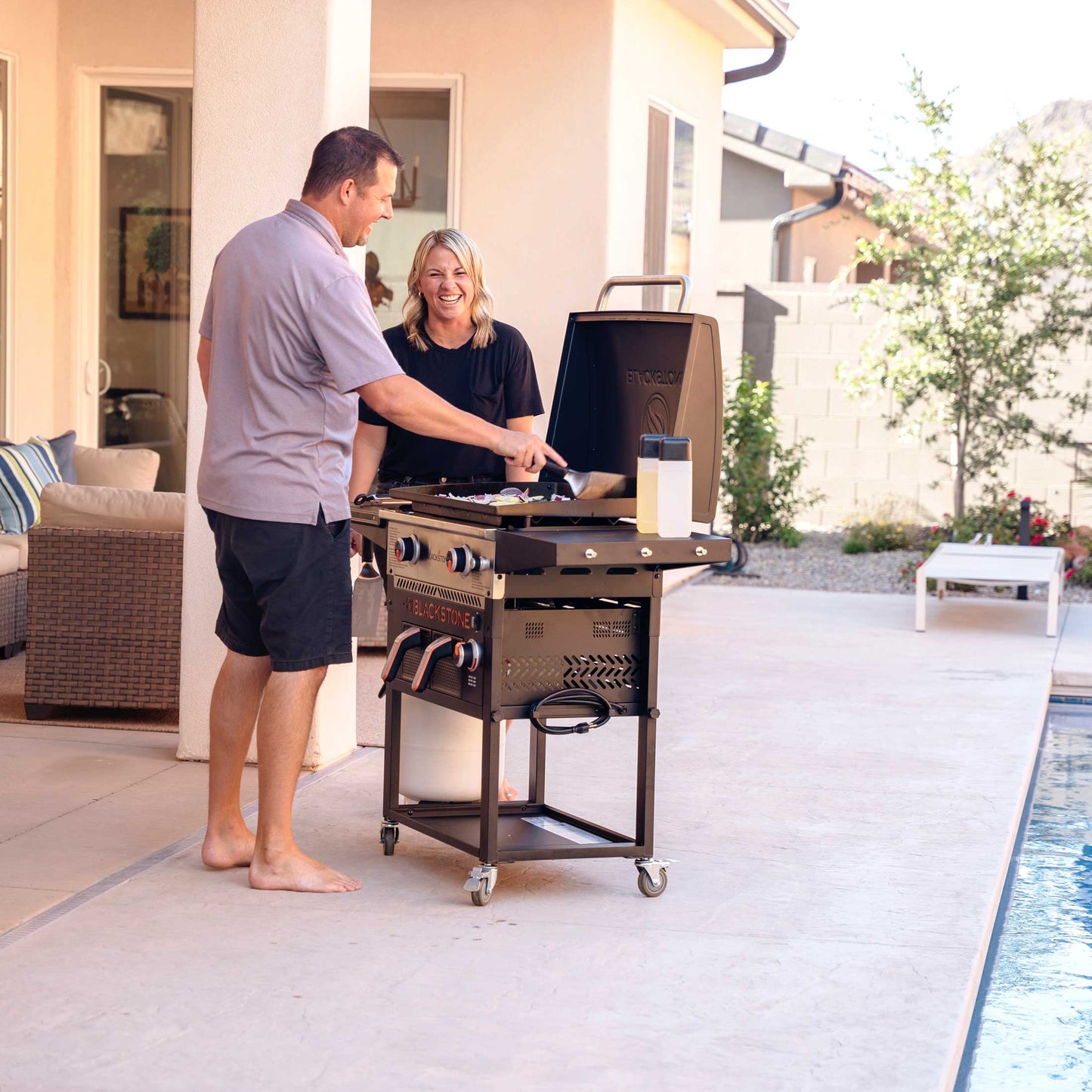 The Foalyard Blackstone 28-inch Gas Griddle Plus AirFryer Combo and Hood - husband and wife