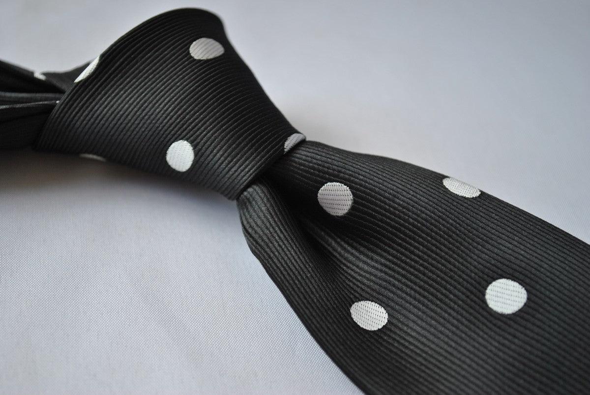 black tie with white polka dots