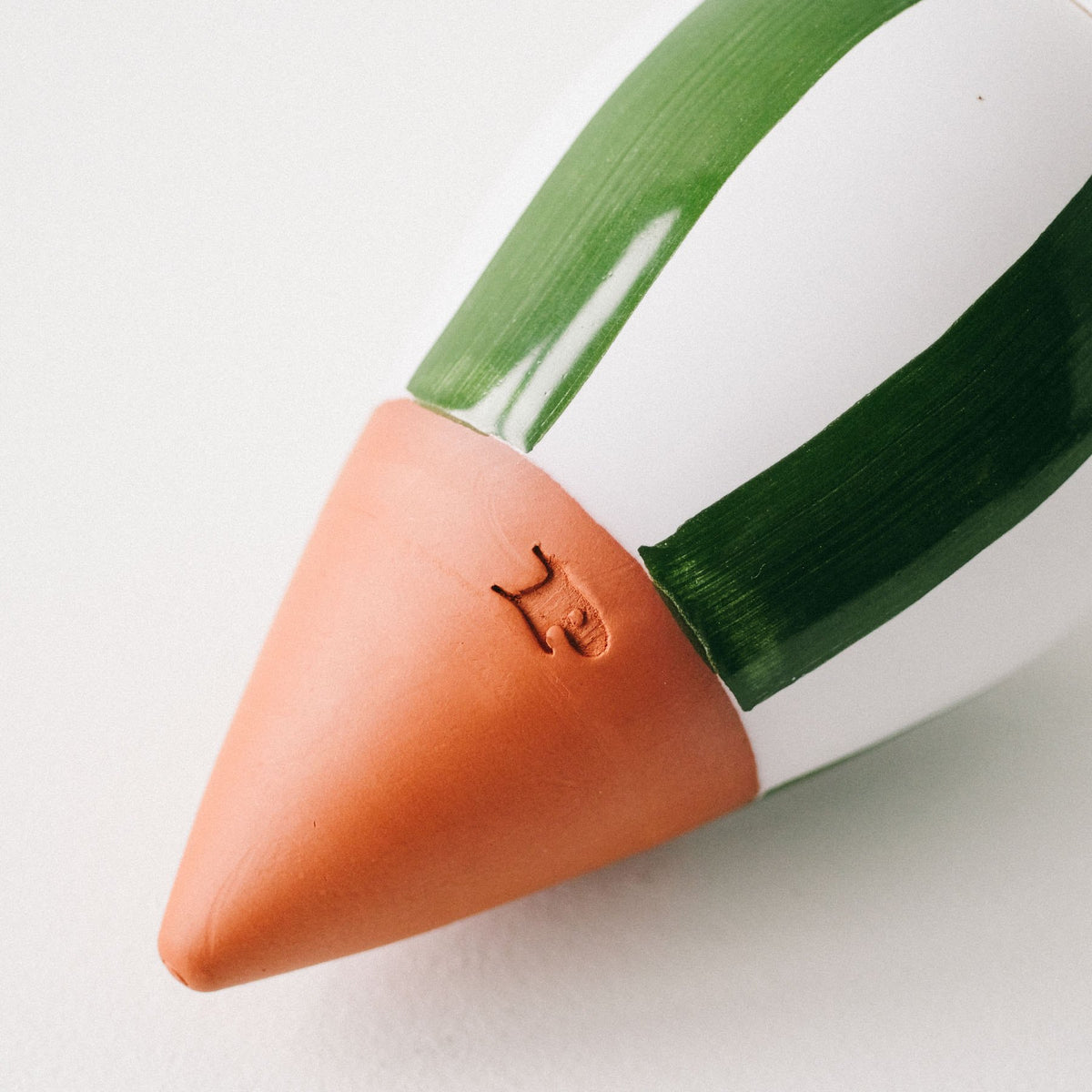 Close-up of the green and white stripes and terracotta tip of the Pepin Olla