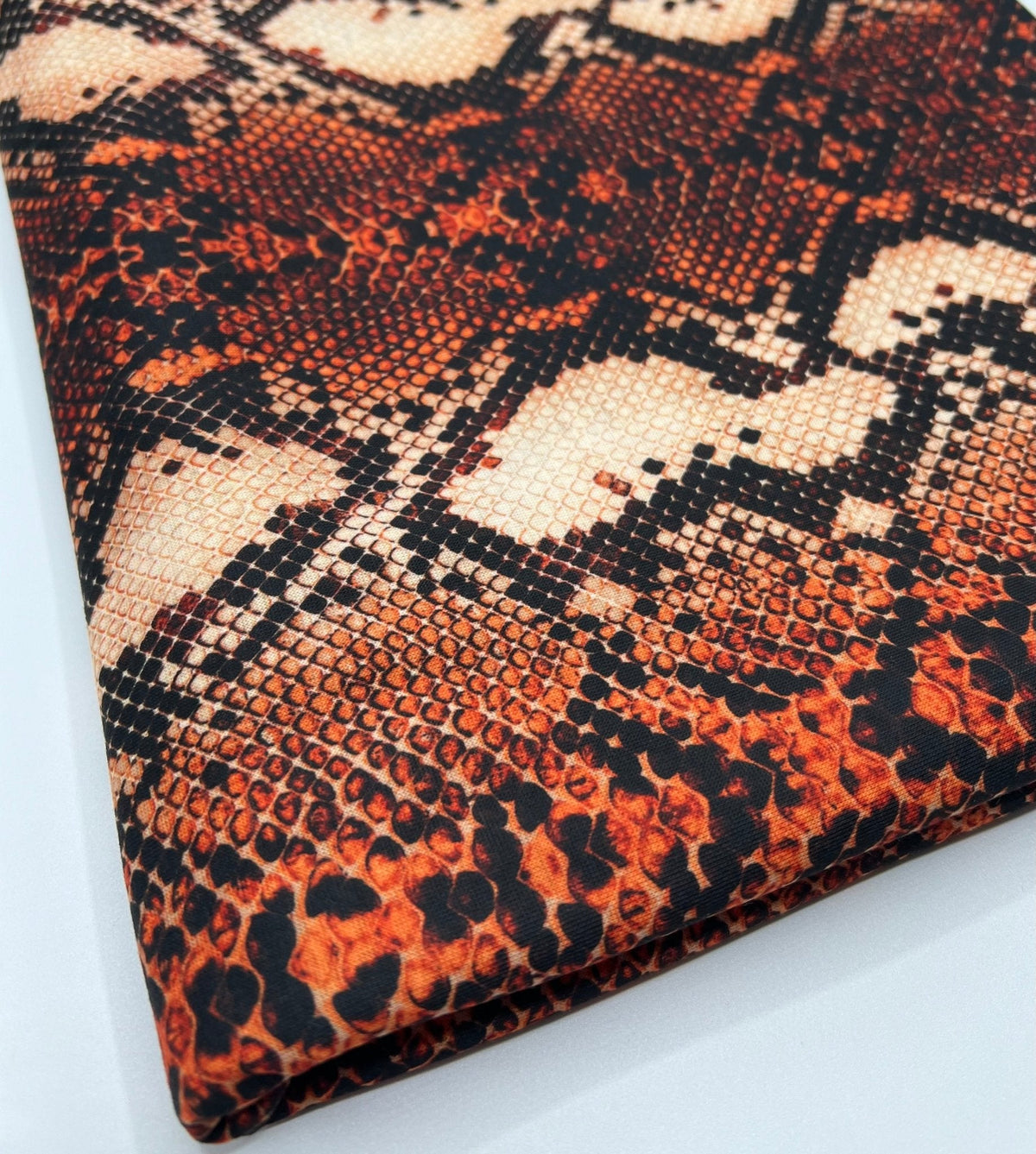 Rust Snake Print Spun Poly Stretch Fabric
