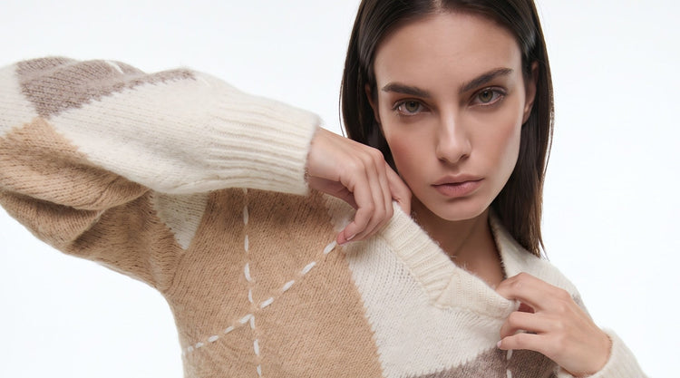 Aftershock London model wearing a neutral patterned knit jumper