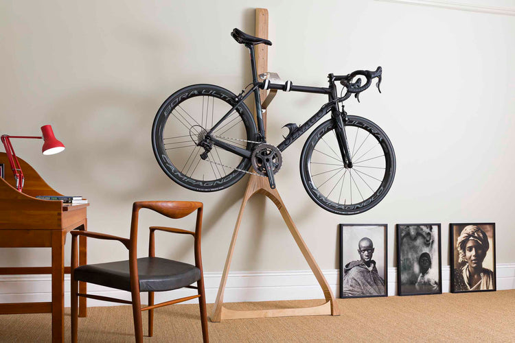 Cactus Tongue Wishbone bike stand displaying a road bike in a stylish interior