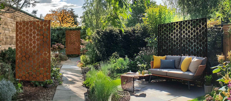 Nicoman decorative metal garden screens in a landscaped outdoor seating area