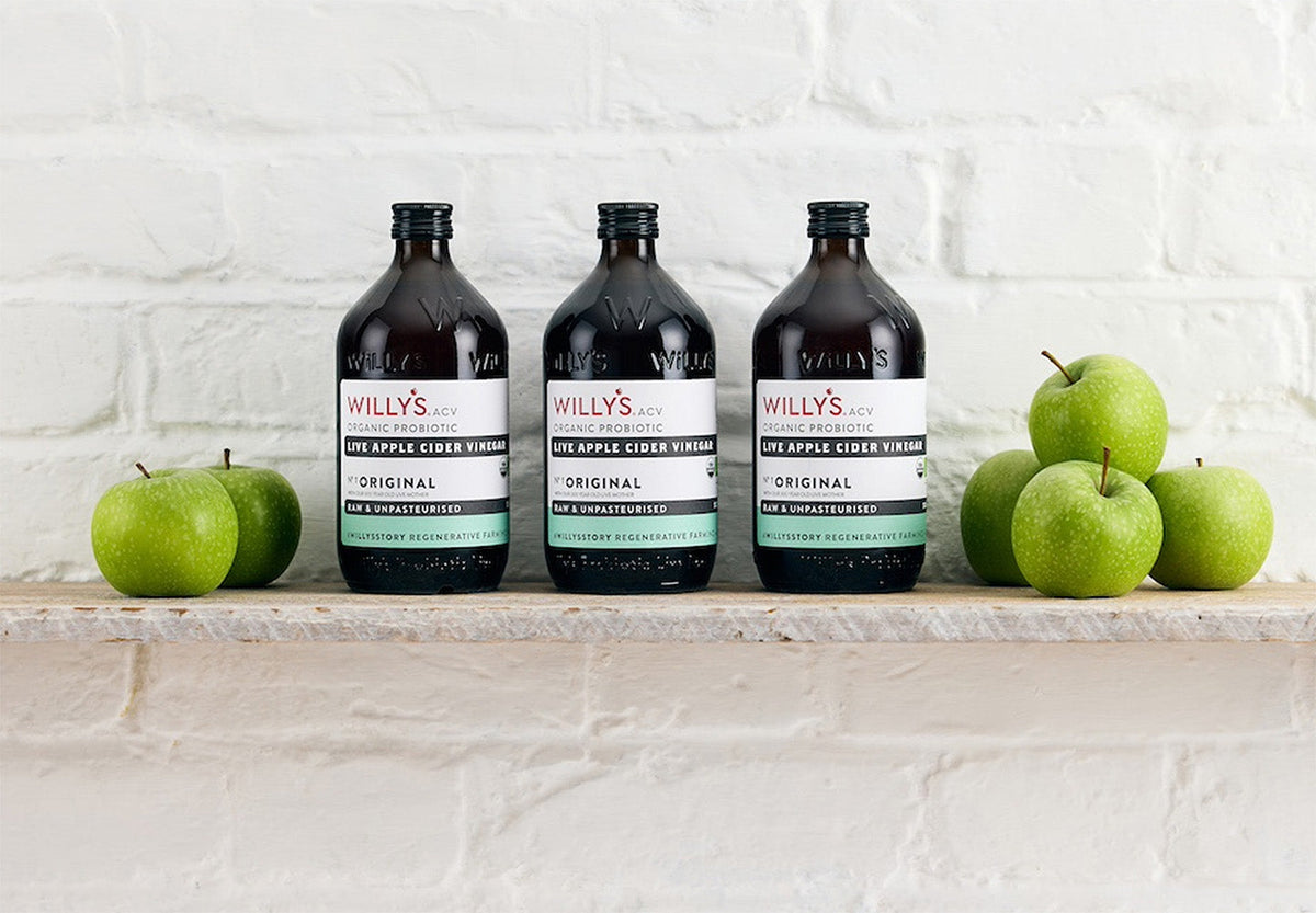 Willy’s ACV organic apple cider vinegar bottles with green apples