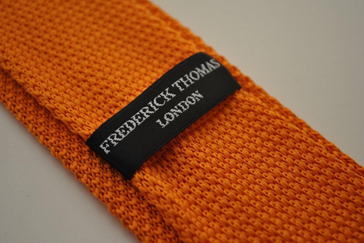 knitted orange tie with royal blue polka dots