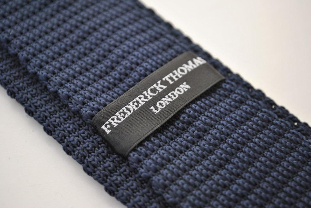 navy blue skinny knitted tie with gold polka dots