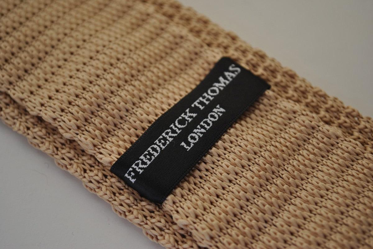 beige skinny knitted tie with white polka dots