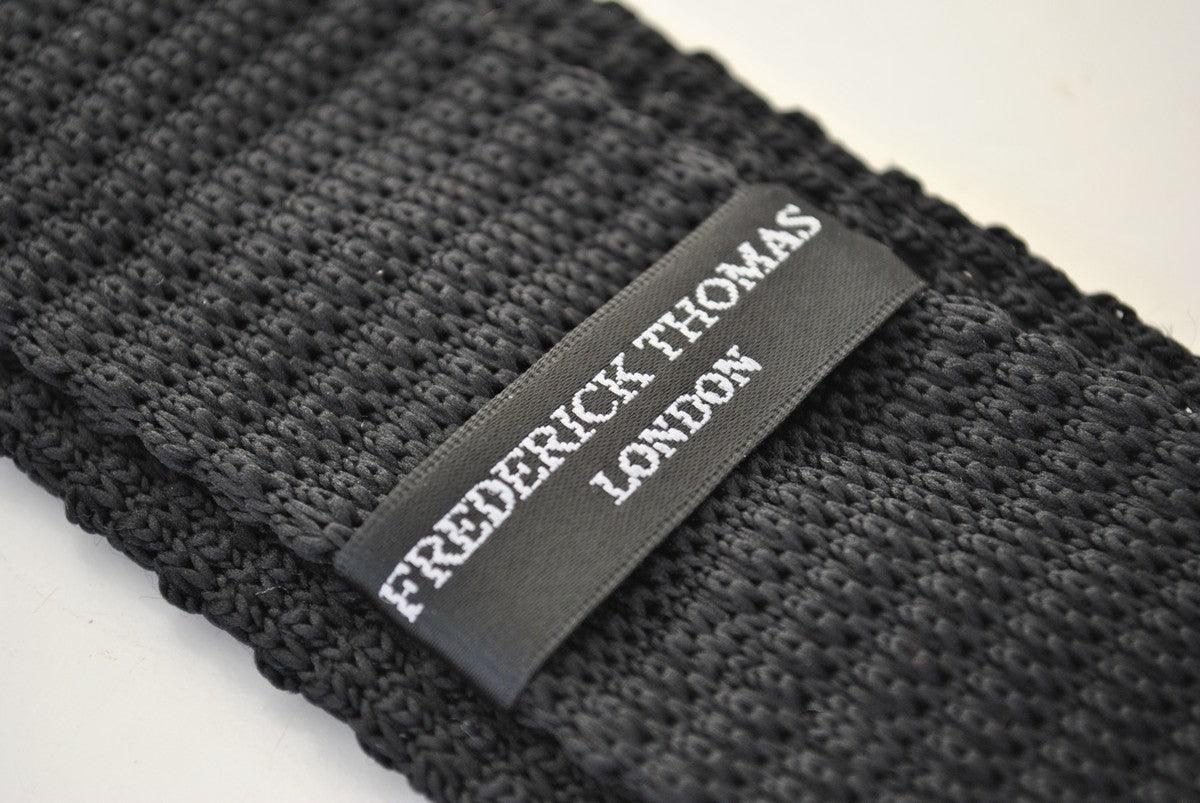 black skinny knitted tie with white polka dots