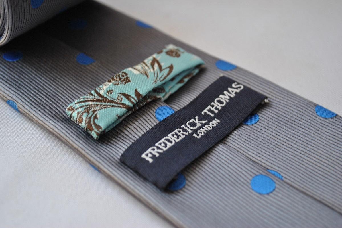 grey tie with royal blue polka dots