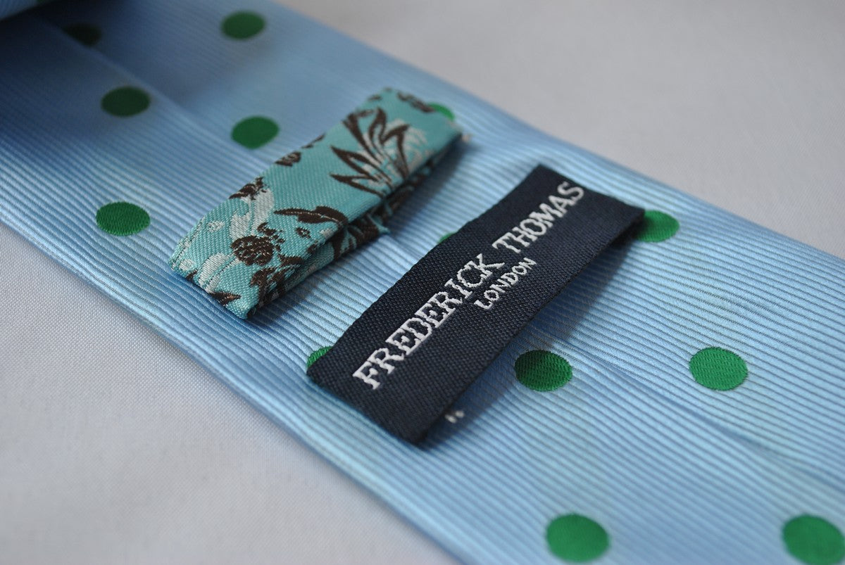 light blue tie with green polka dots