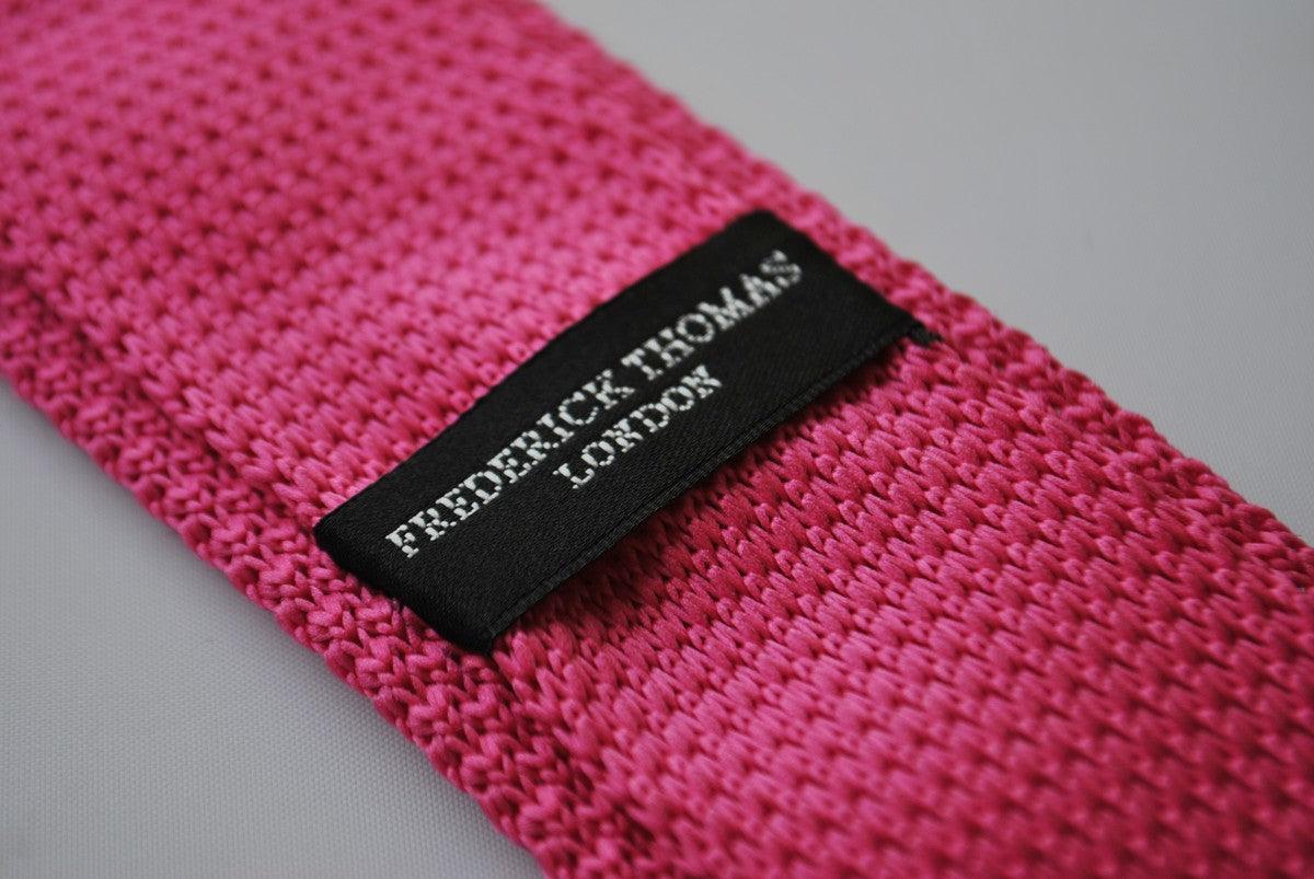 bright pink skinny knitted tie with white polka dots