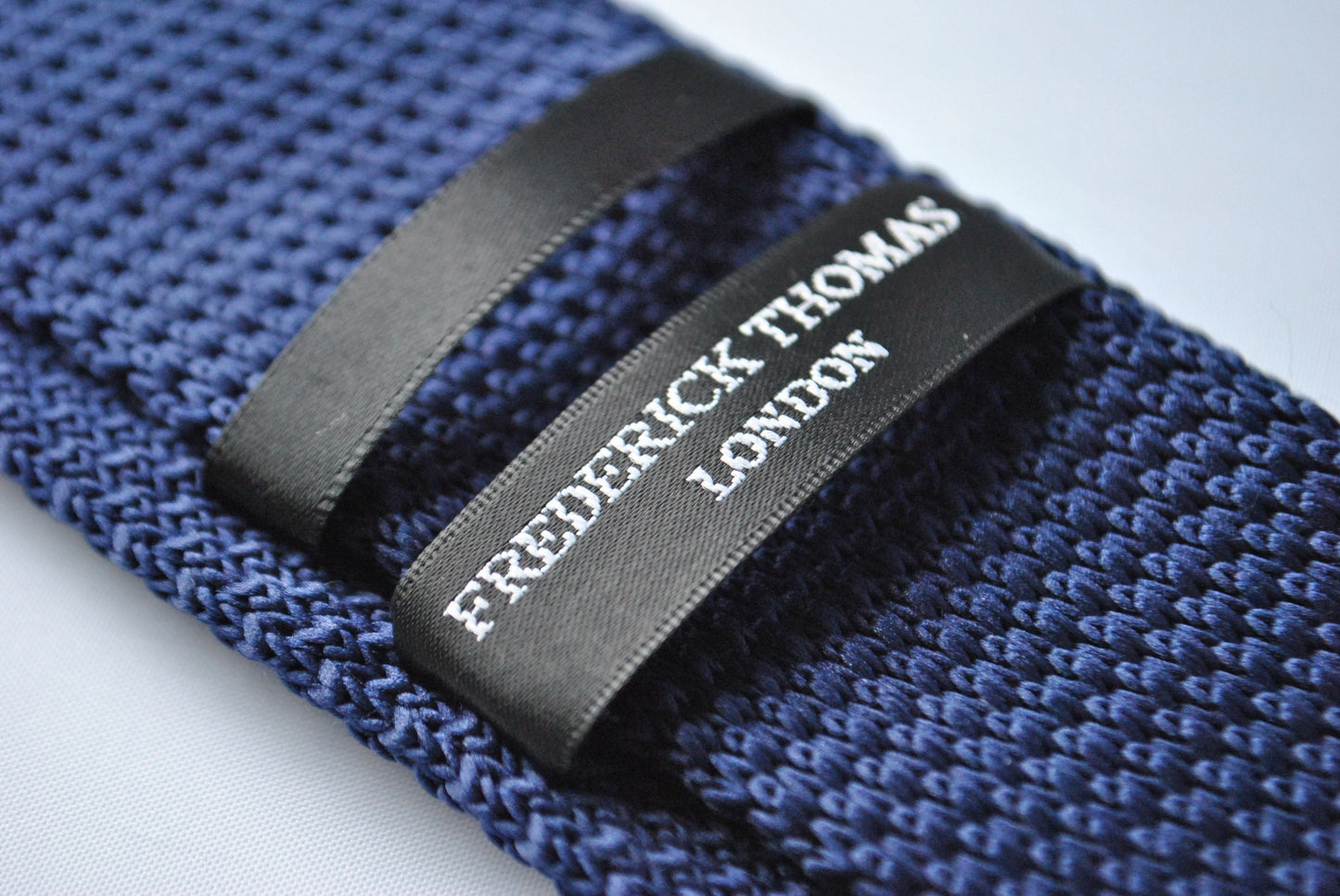 navy blue skinny knitted tie with light blue polka dots