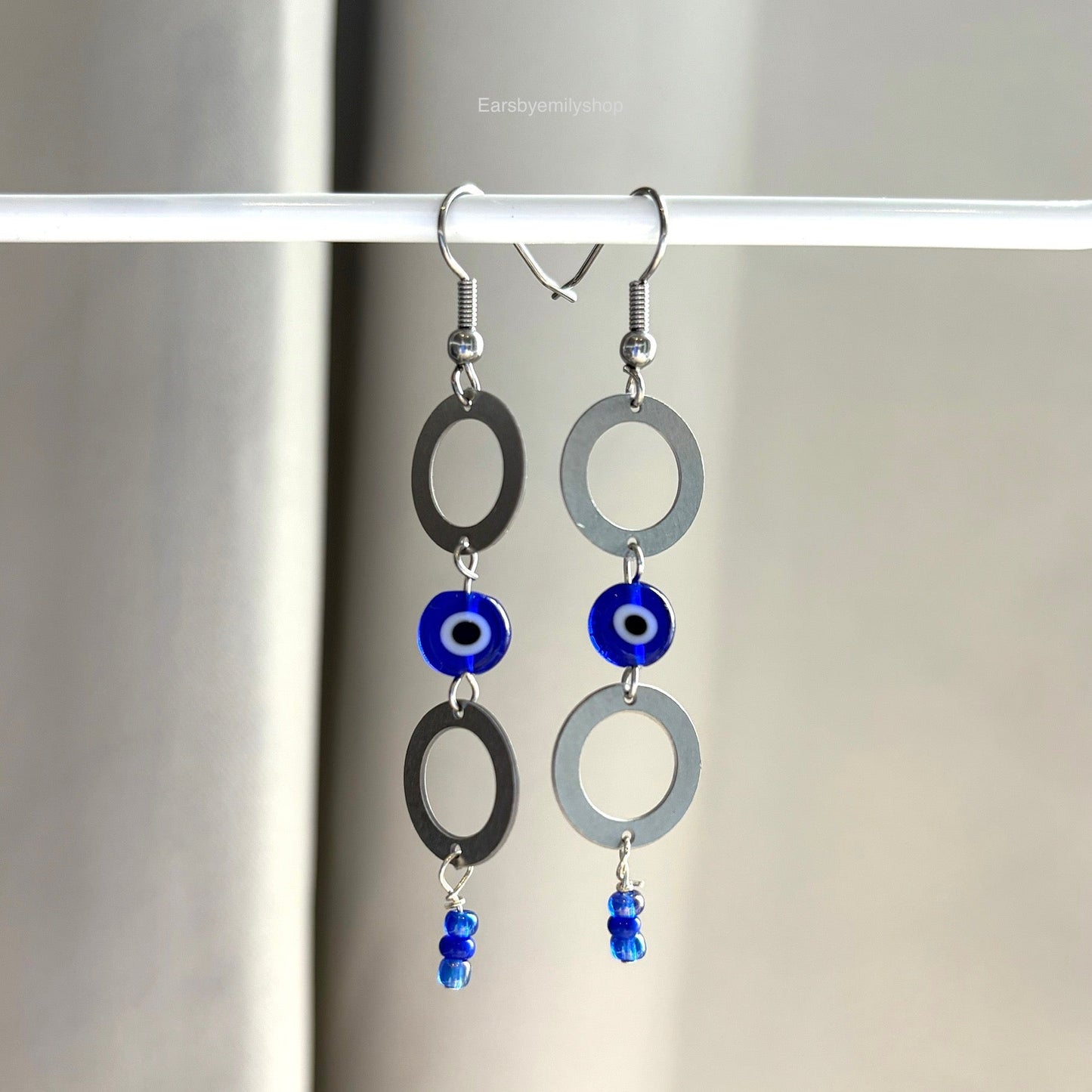 Stainless steel circle and blue evil eye bead statement dangle earrings