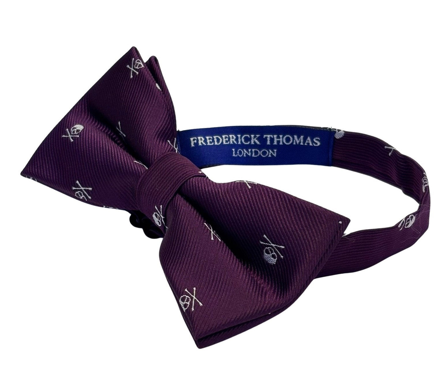 matching purple bow tie and pocket square with white skull and crossbone design