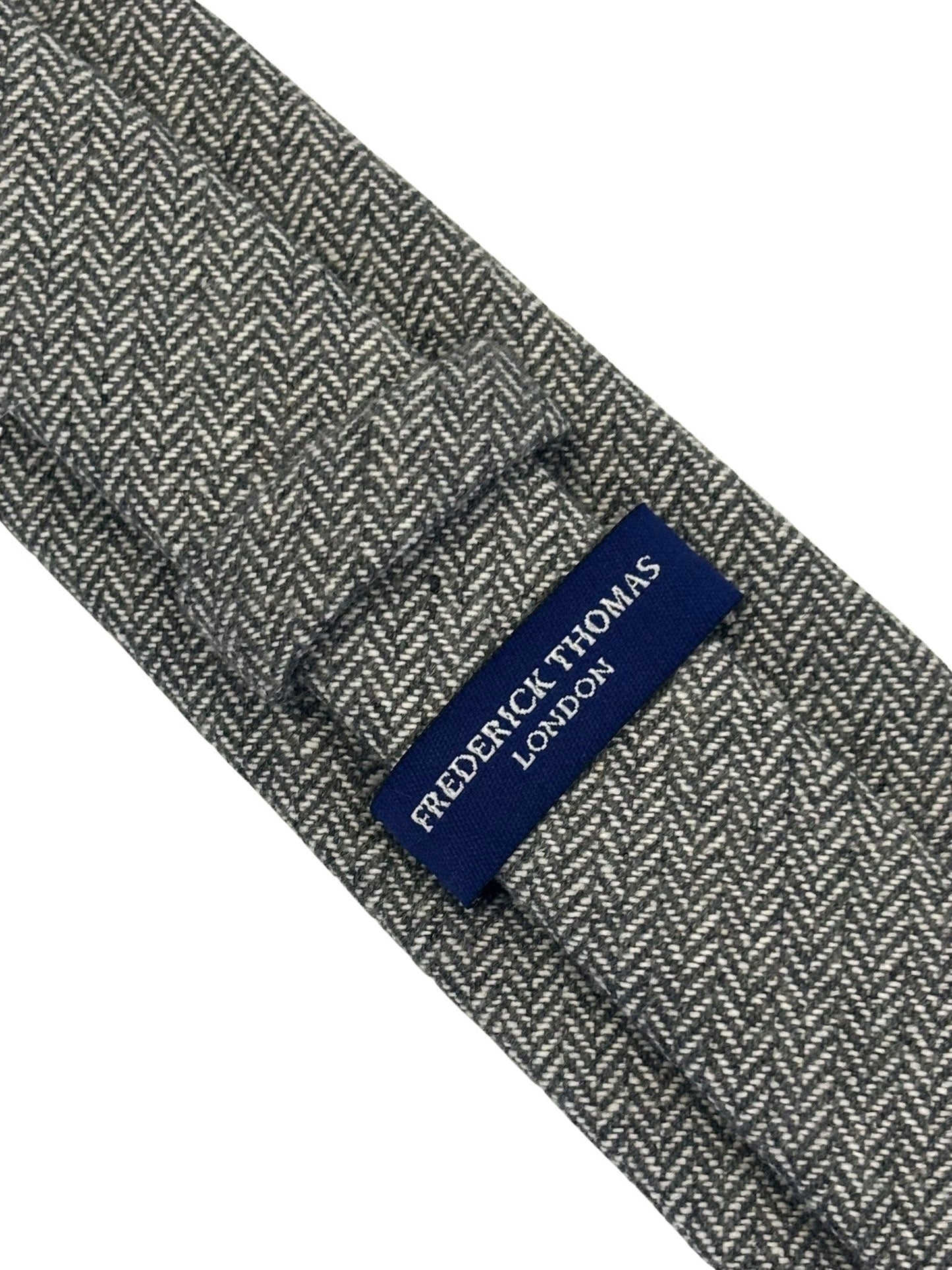 dark grey and cream wool tie with a herringbone design