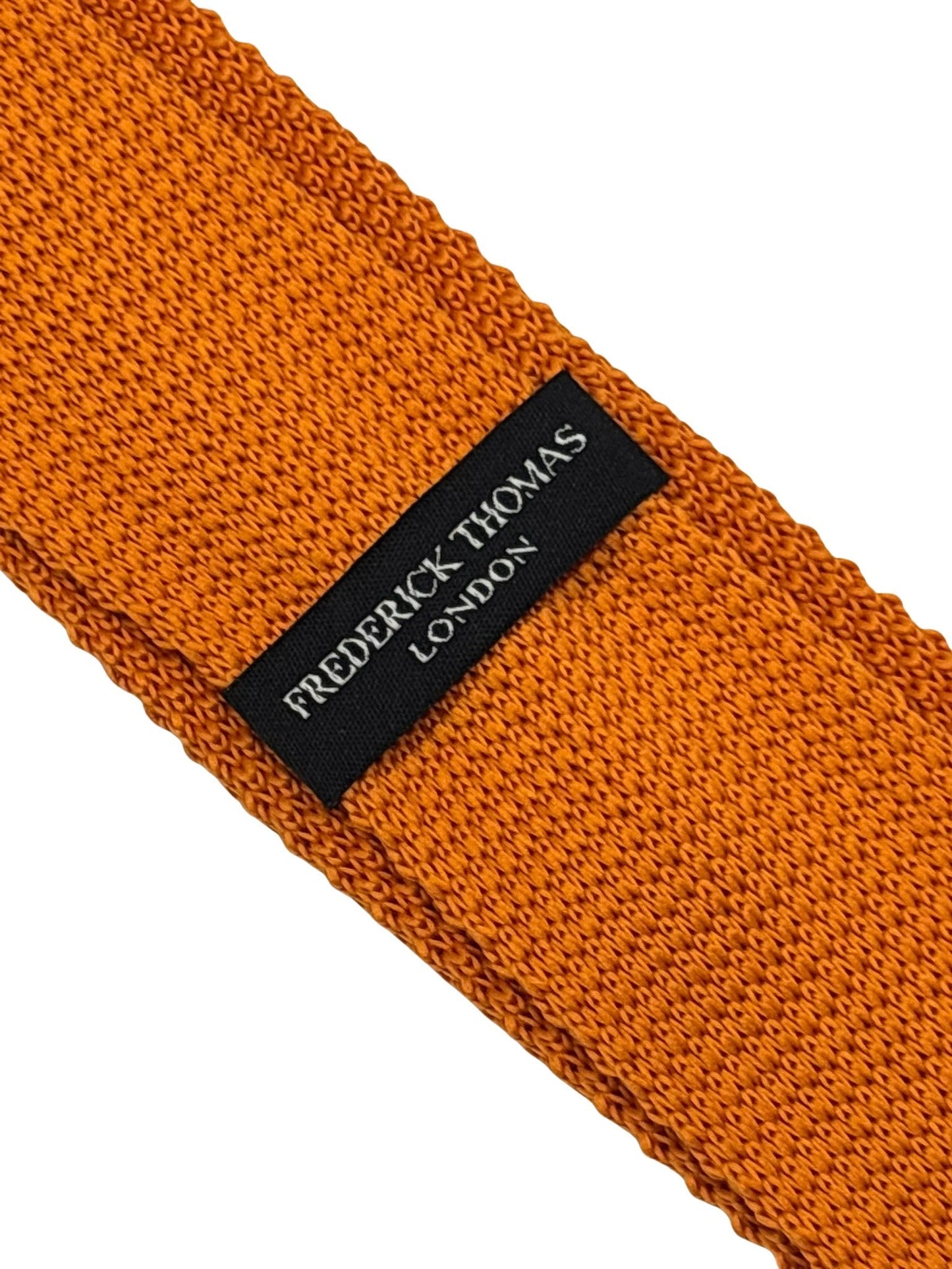 knitted tie in  bright orange with emerald green polka dots