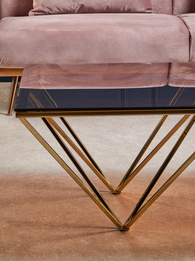 Red-Tinted Tempered Glass Top Coffee Table with Geometric Prismatic Champagne Metal Legs | Allure