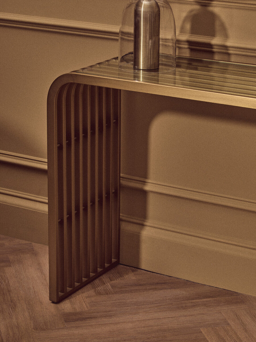 Matte Gold Slatted Console Table with Clear Glass Top | Vogue