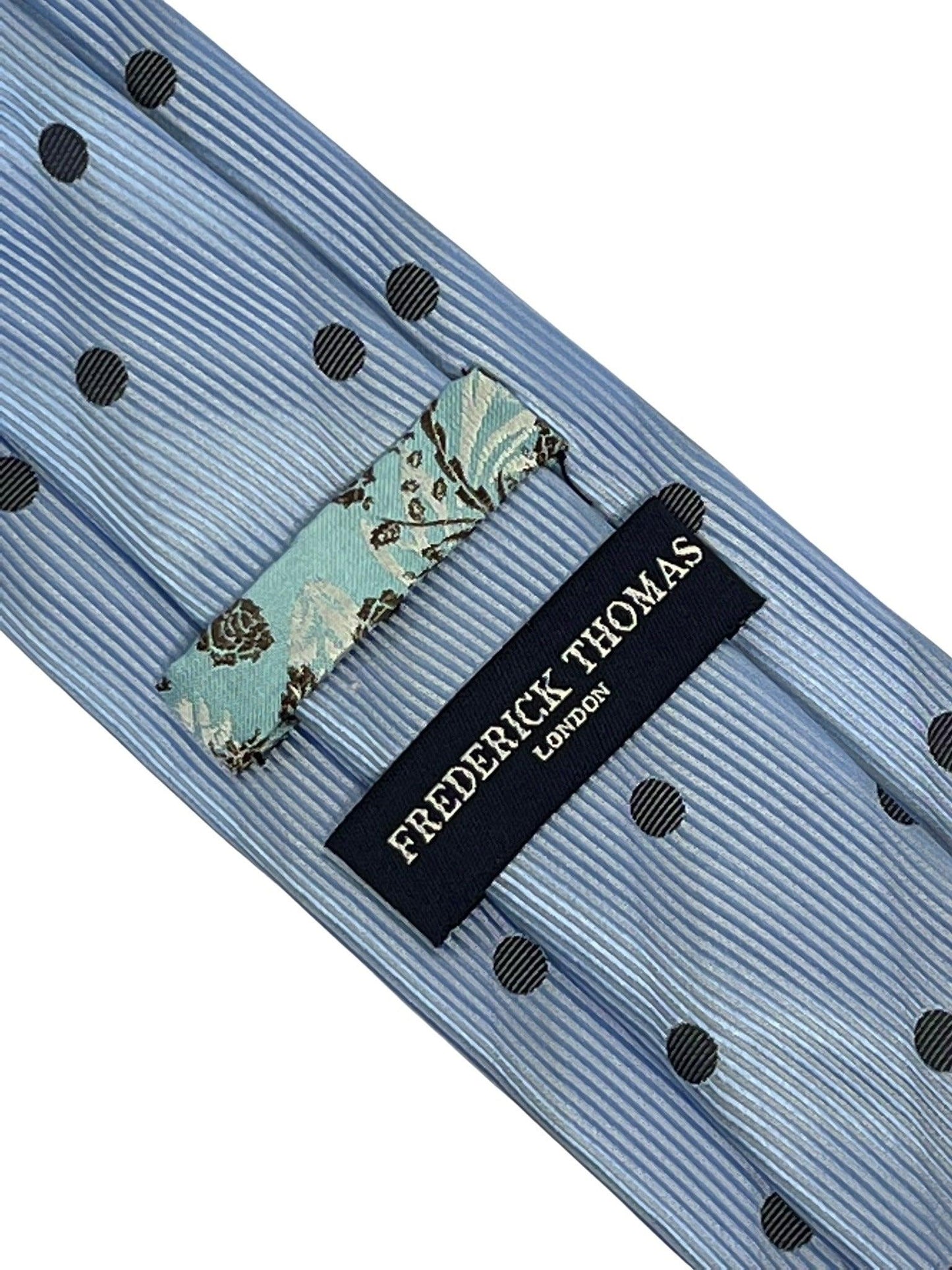 light blue tie with black polka dots
