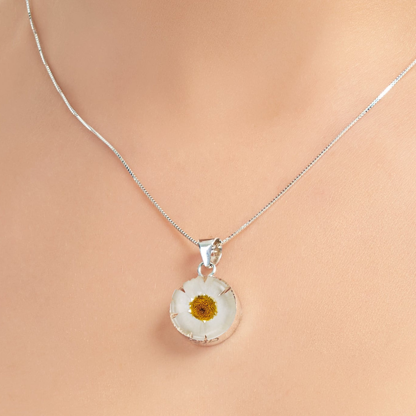 Daisy necklace by Shrieking Violet® Sterling silver & real daisy in a round pendant.