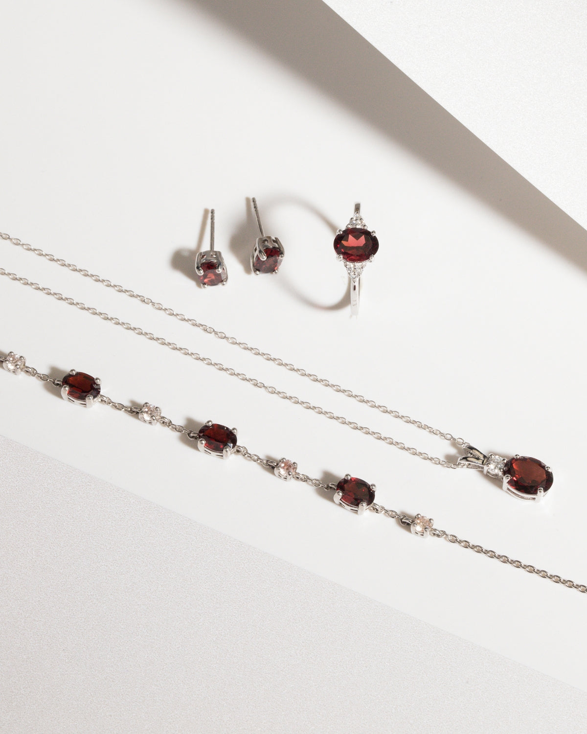 Garnet Oval Stud Earrings in Sterling Silver