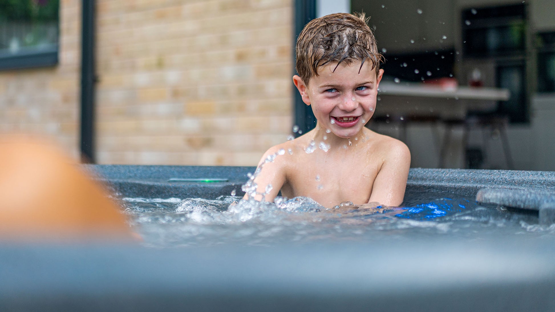 TheFoalyard RotoSpa OrbisSpa hot tub Granite Grey with Dark Grey panels British Made - bubbling water playing back garden home jacuzzi