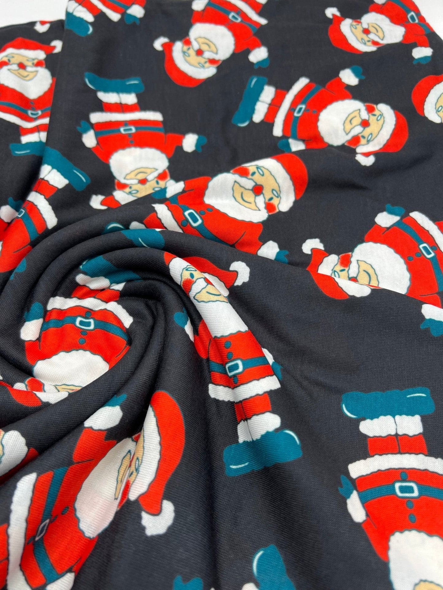 Black Rosy Cheek Santa Print Soft Spun Poly Stretch Fabric