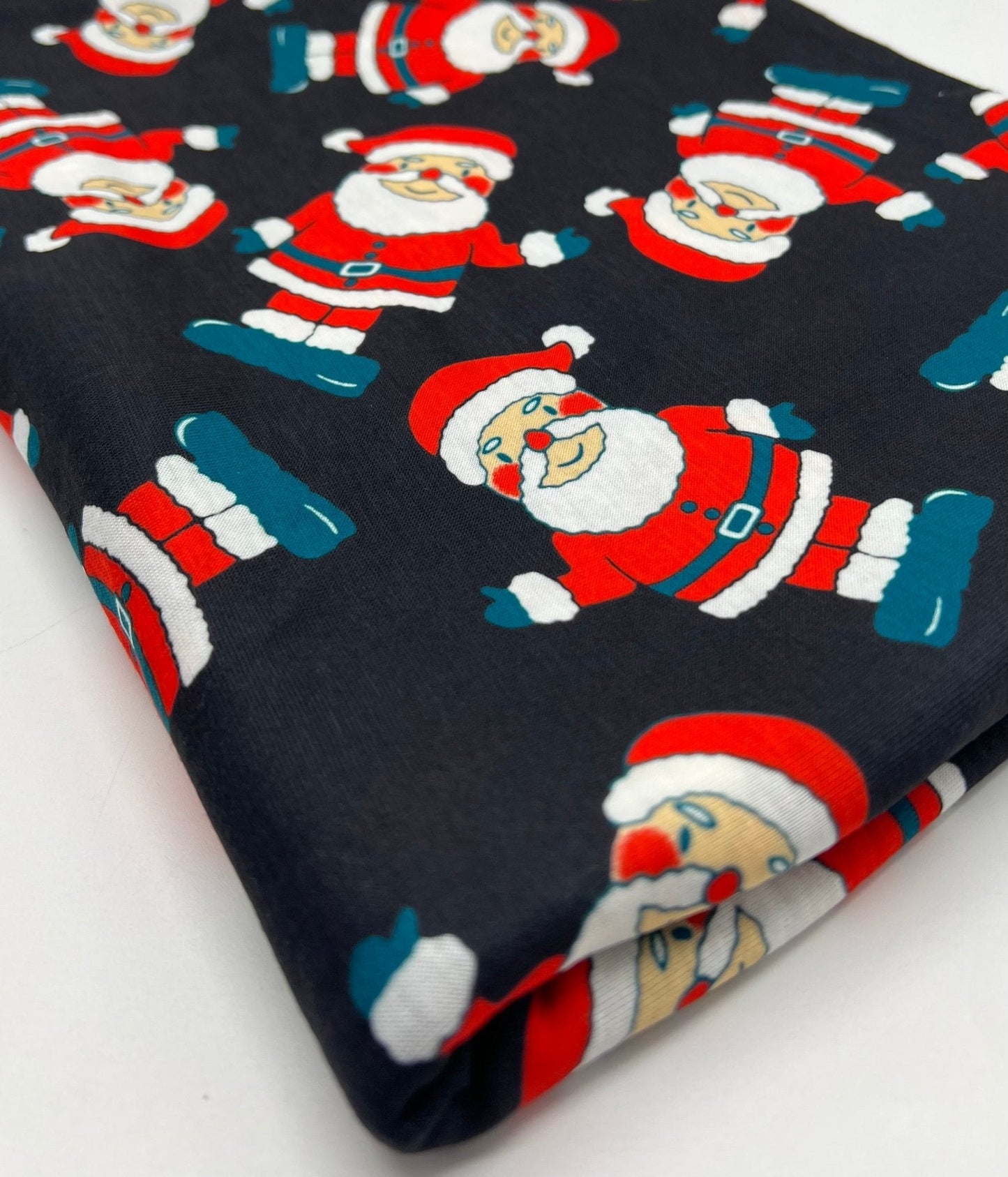 Black Rosy Cheek Santa Print Soft Spun Poly Stretch Fabric