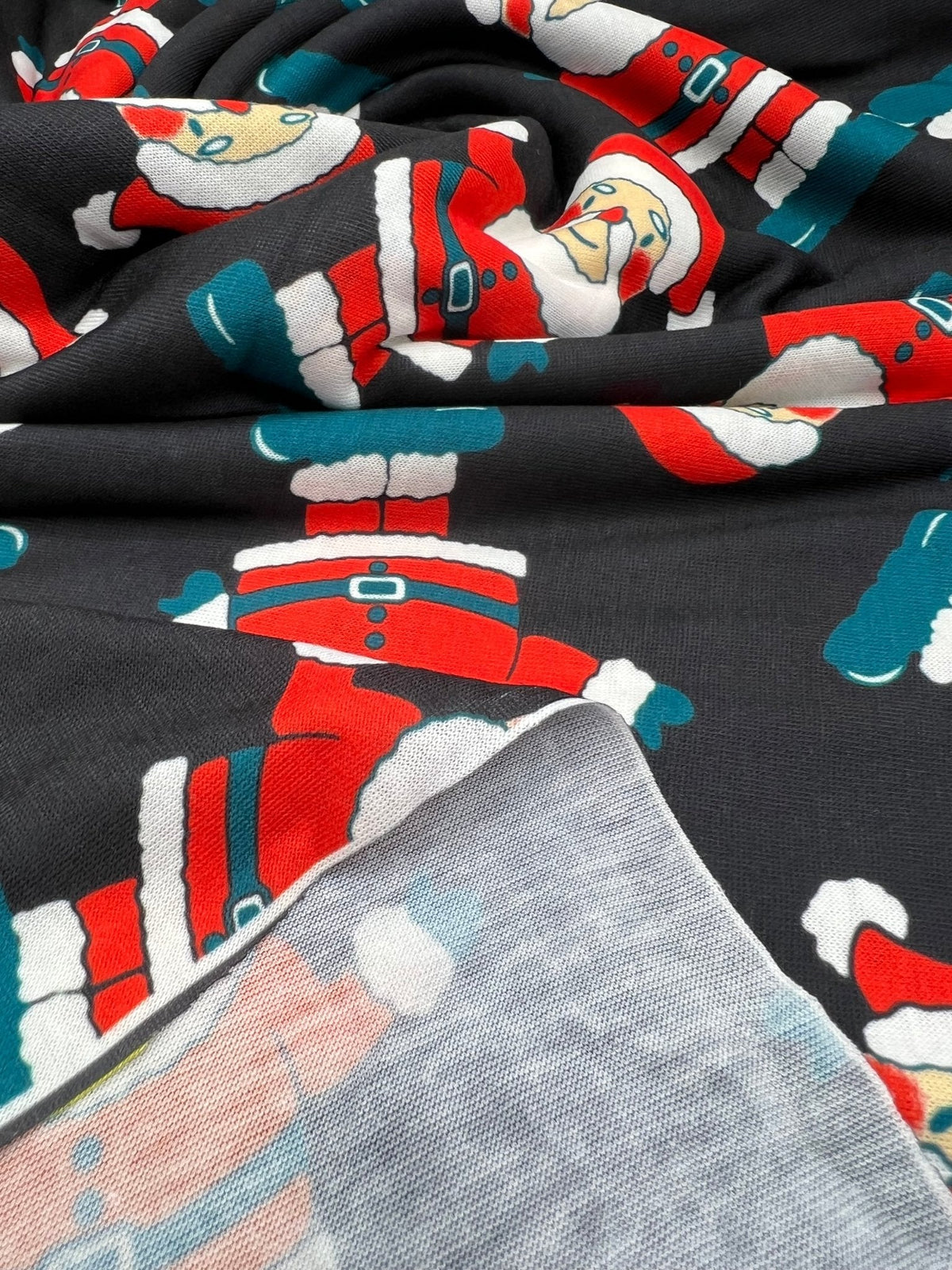 Black Rosy Cheek Santa Print Soft Spun Poly Stretch Fabric