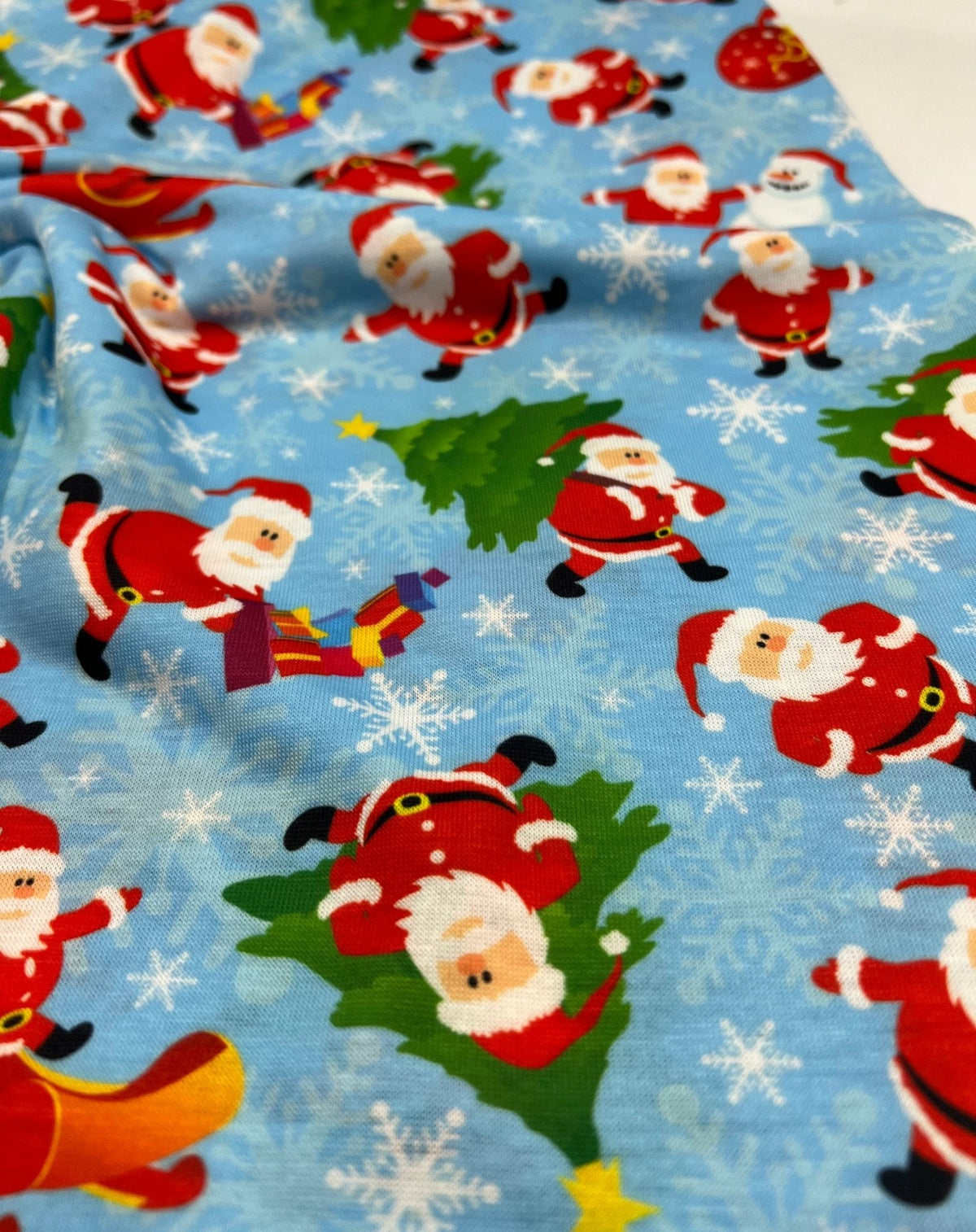 Blue Santa Sledge Print Soft Spun Poly Stretch Fabric