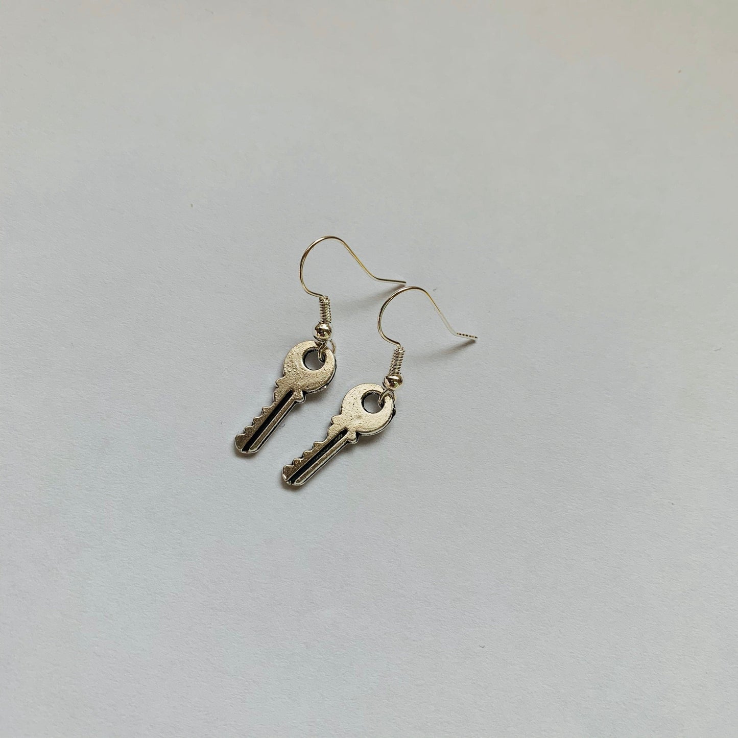 Little silver key dangle earrings