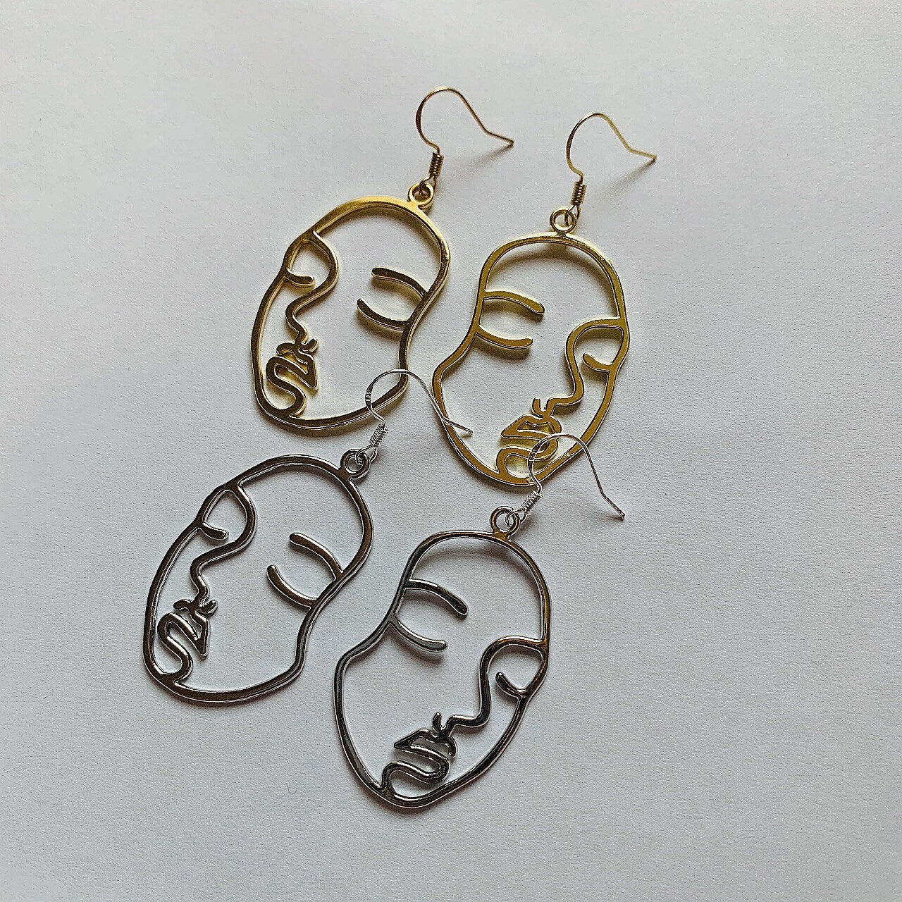 Silver or gold face outline earrings