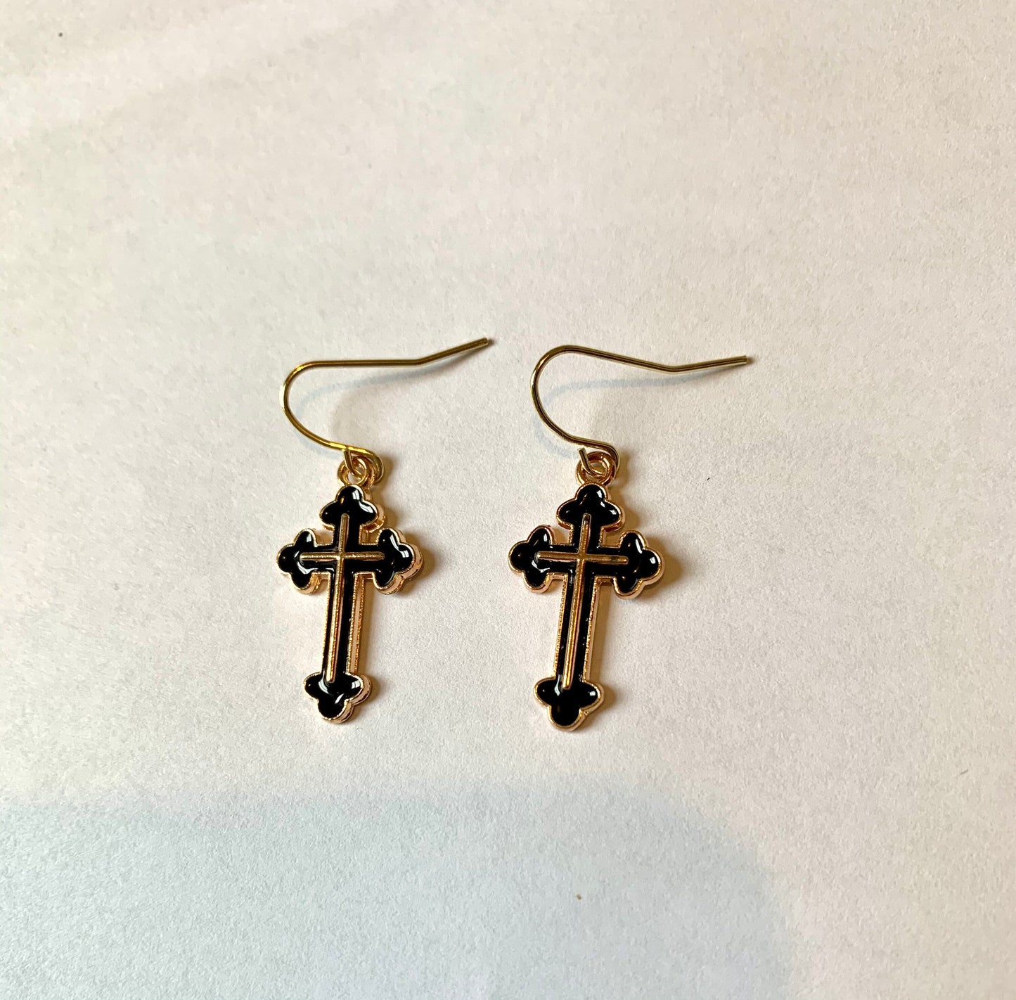 Black and gold cross dangle earrings on gold plated hooks