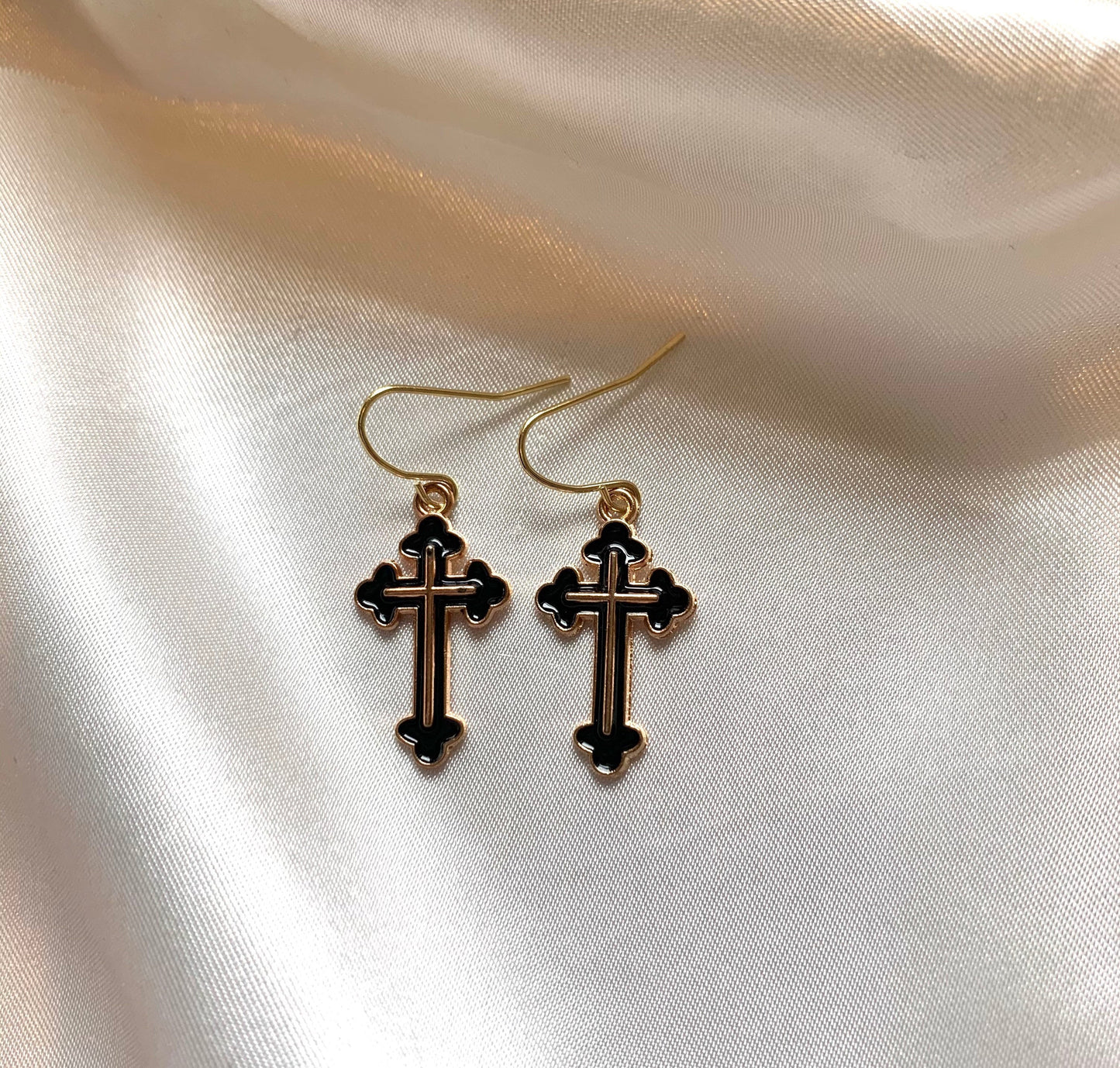 Black and gold cross dangle earrings on gold plated hooks