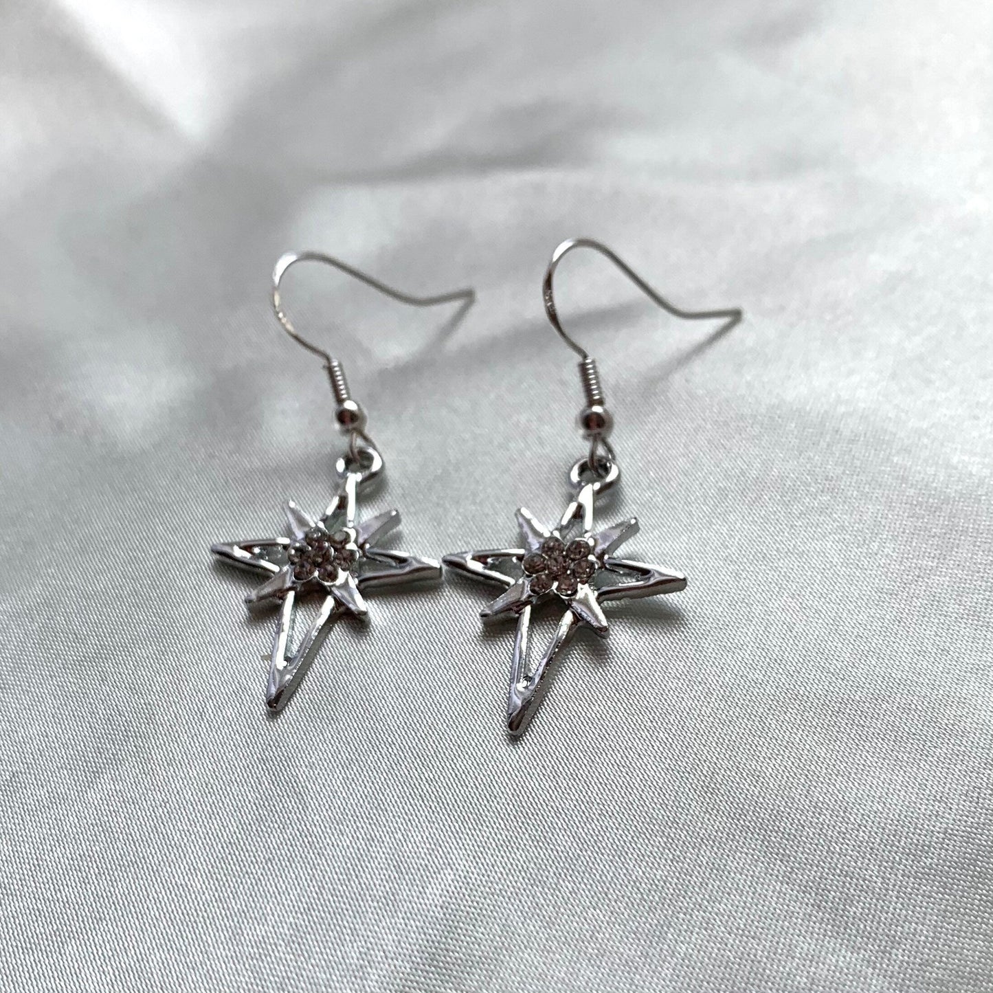 Silver north start diamante dangle earrings