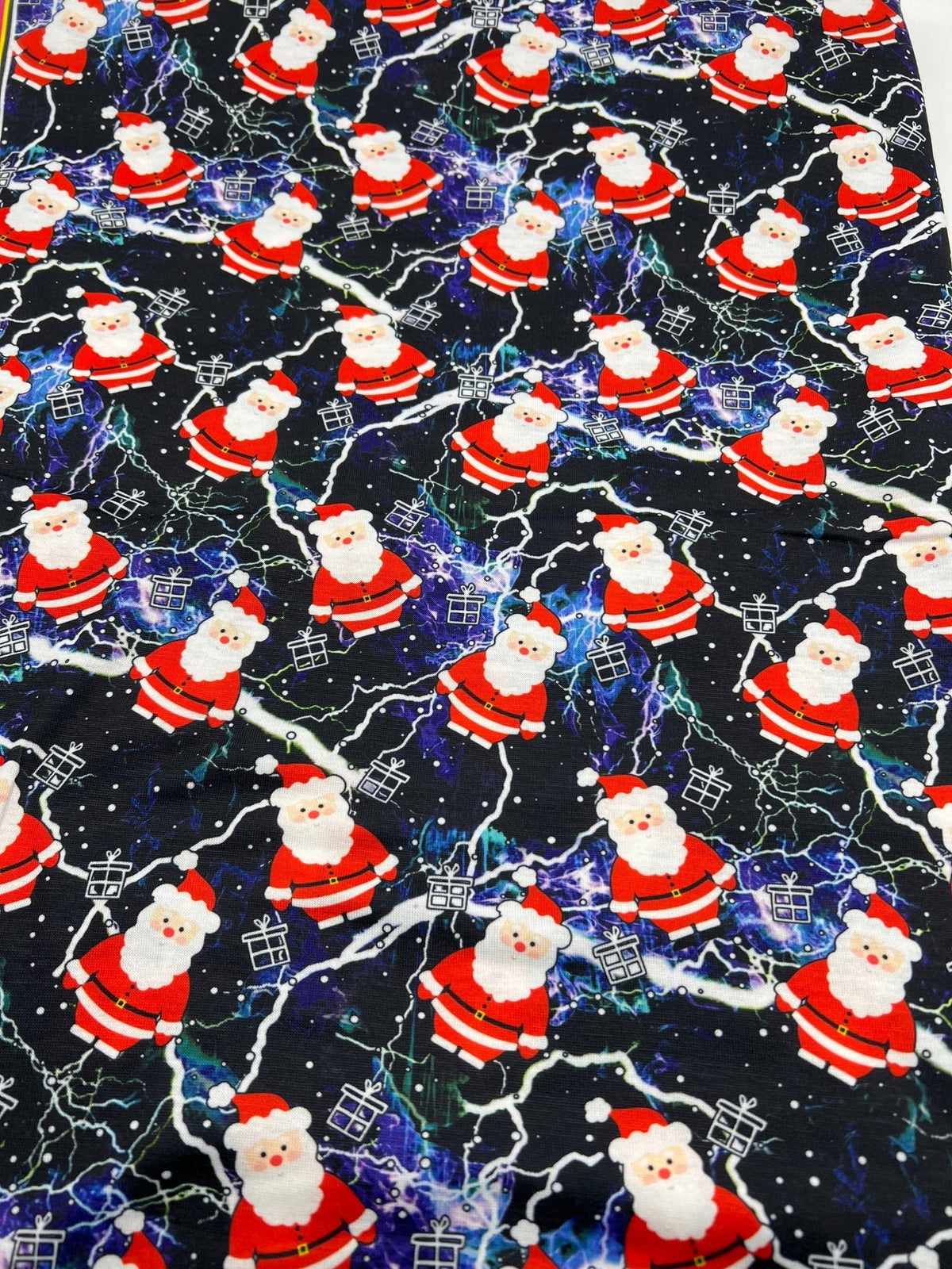 Lightning Santa Print Soft Spun Poly Stretch Fabric