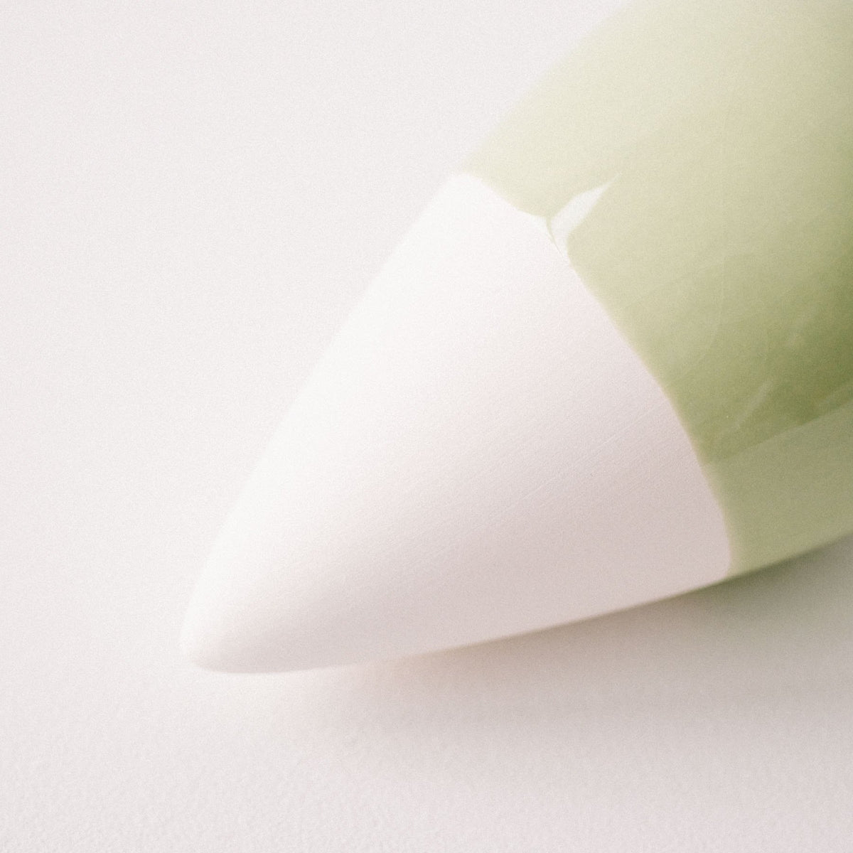 Close-up of the white unglazed tip and sage green glaze of the Pepin Olla