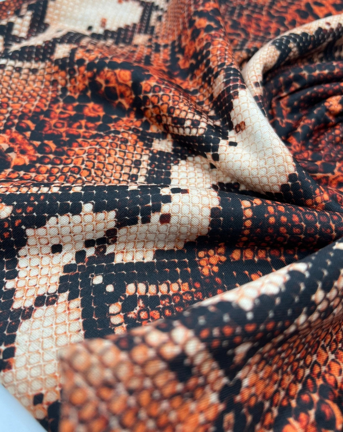 Rust Snake Print Spun Poly Stretch Fabric