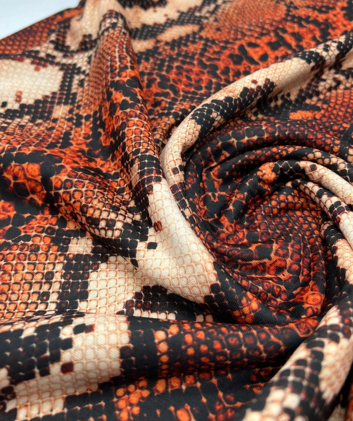 Rust Snake Print Spun Poly Stretch Fabric