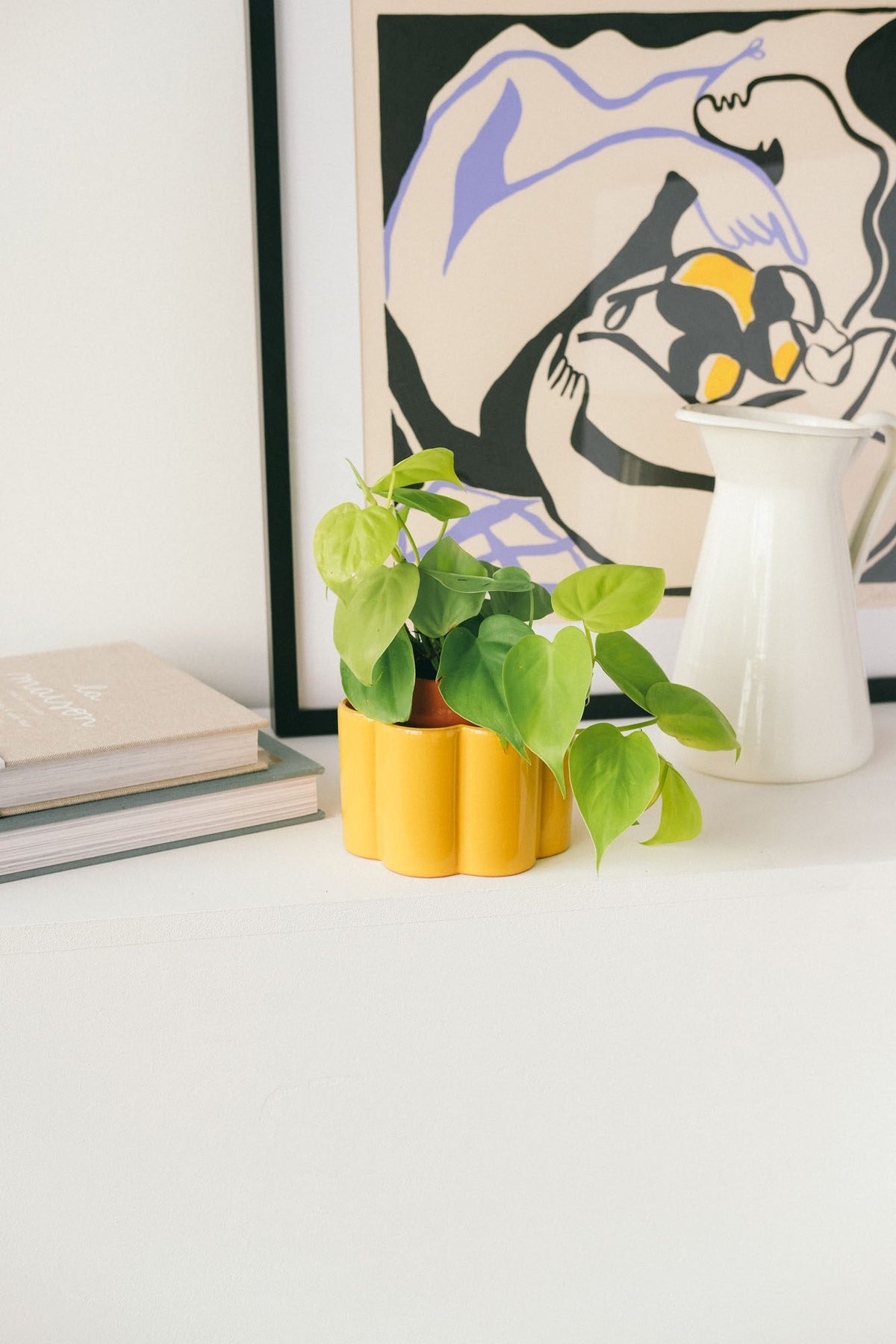 Mustard yellow Pepin Paulita self-watering pot with a houseplant