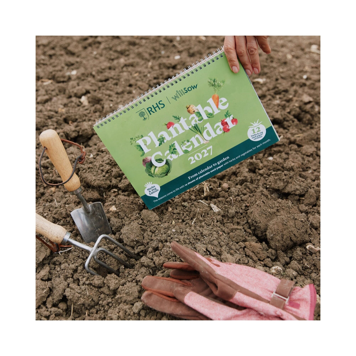 RHS & Willsow A4 Veg & Herb Desk Calendar 2027 on garden soil with trowel