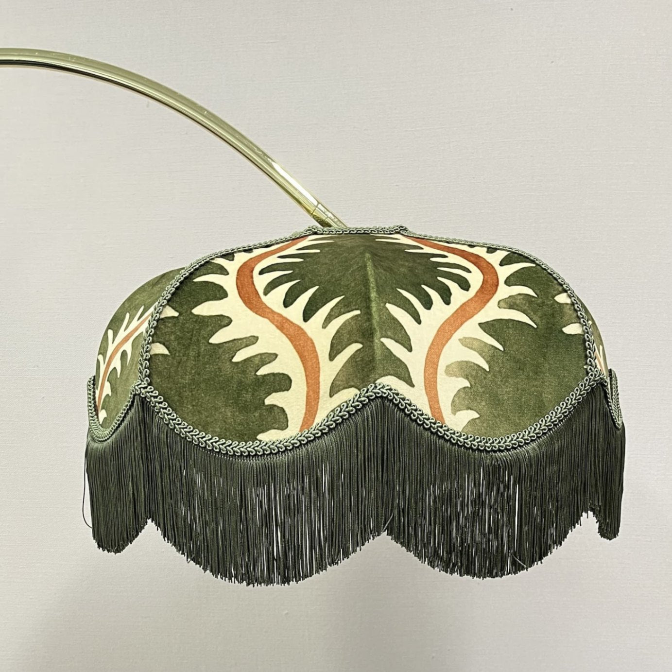 Tinker & Tallulah pink velvet fringed lampshade on a brass table lamp